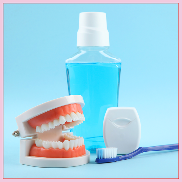 An image of mouthwash, a dental model, floss, and a toothbrush.
