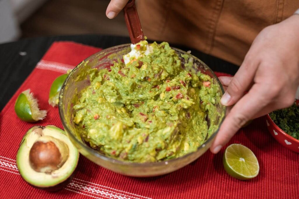 Bowl filled with vibrant green guacamole, a refreshing and flavorful dip.
