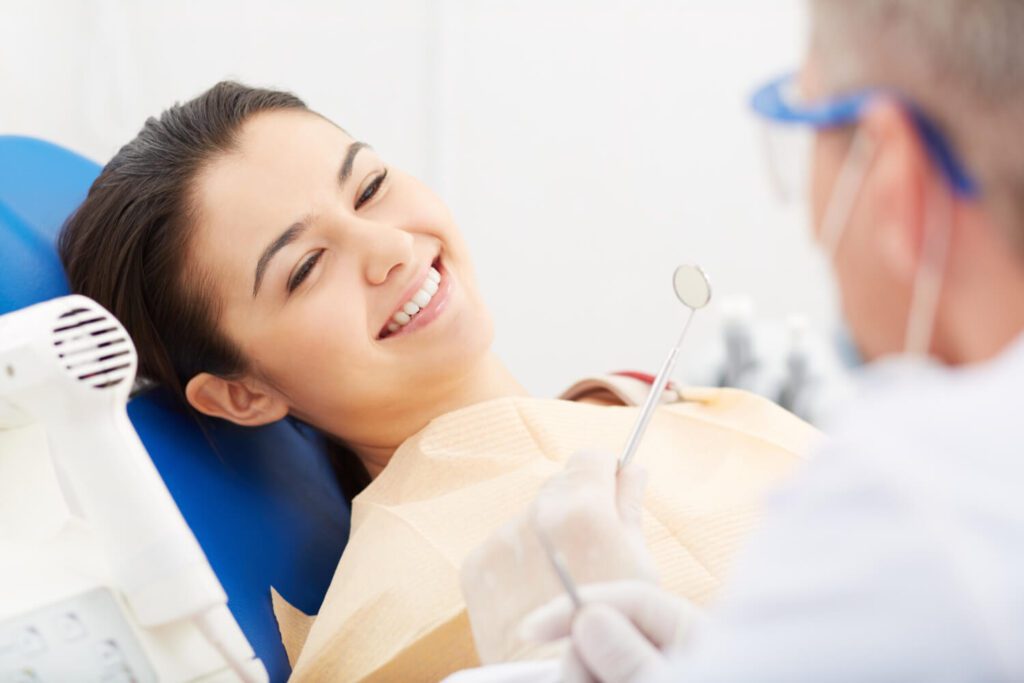 A photograph of a woman undergoing All-on-4 treatment at the dentist's office.
