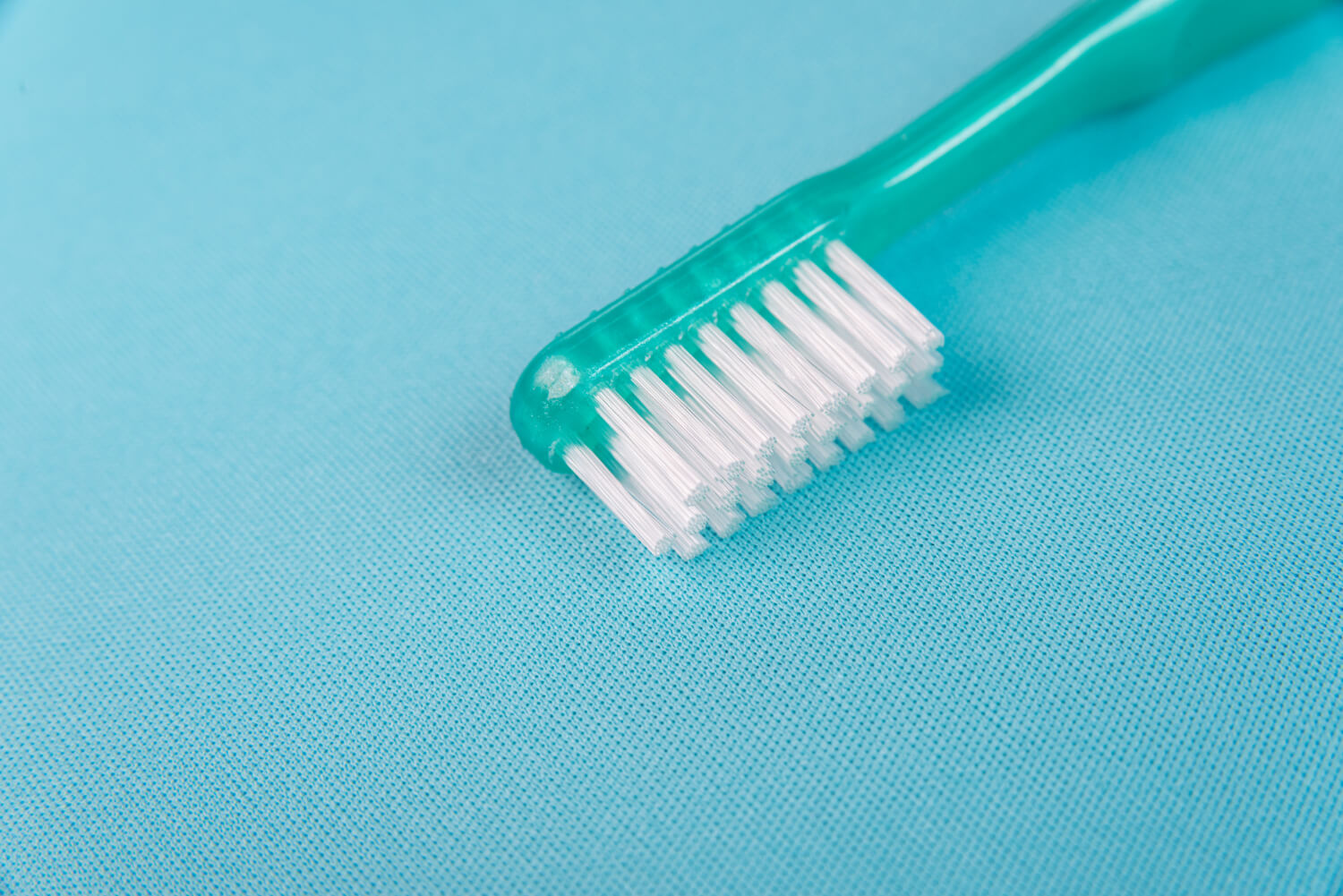 A captivating photo of a turquoise toothbrush, symbolizing the vibrant care you can give your smile.