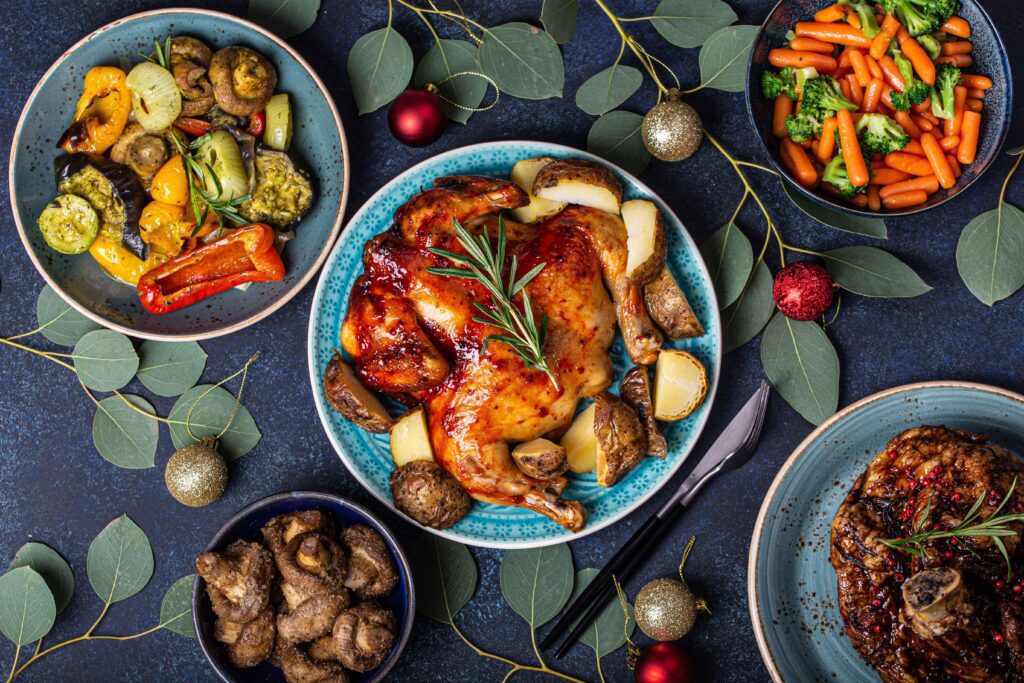 A top view of a Christmas feast table with flatlay food.