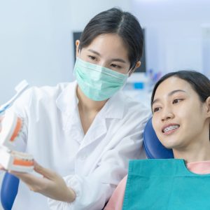 two young women inside a consult with a dentistry looking a denture